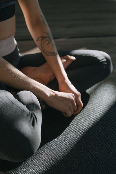 Close-up of a person's hands in a relaxed meditative pose.